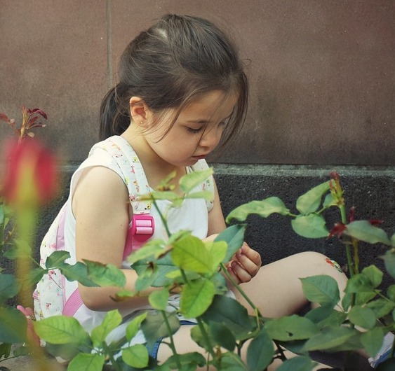 kid planting a seed for a lesson on kindness